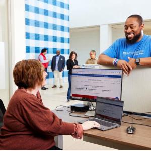 2 employees chat at a desk