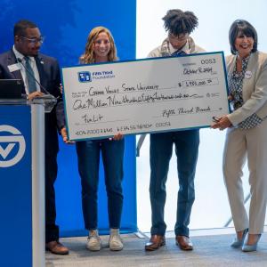 Small group receiving check on stage 