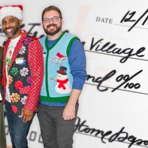 group in festive clothing with an oversized check