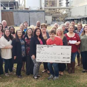 Group of people with a big check from International Paper 