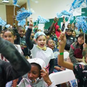 Youth at Astronaut José M. Hernandez Academy cheering at a Project UP digital equity grant announcement in Stockton.