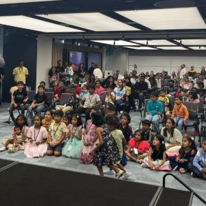 Employees and their children watching a presenter