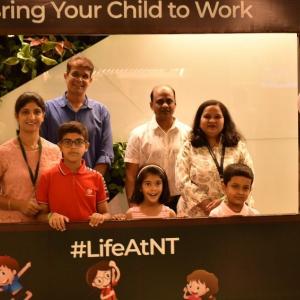 Employees and their children behind a photo prop