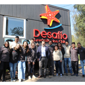 People posed in front of a building "Desafio" logo on the side.