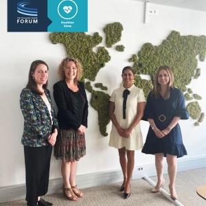 4 women in front of a map of the world