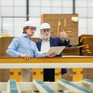 Two people in hard hats in a manufacturing scene.