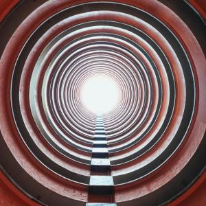 Looking through a long tunnel towards a bright light.