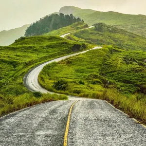 A winding road up a hilly landscape