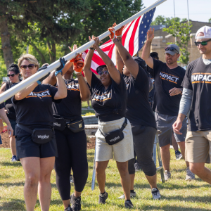 A group raising an American flag