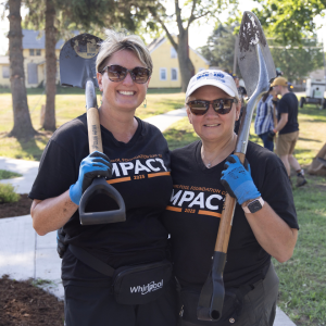two volunteers with garden tools