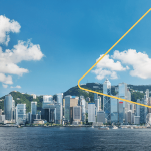 City skyline with an expanse of water in front. A few clouds in a blue sky above.