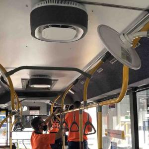 people cleaning a bus empty of passengers