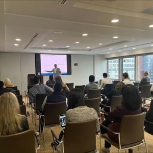 seminar attendees in chairs looking at a speaker
