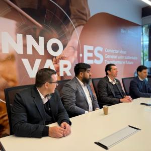 4 people seated at a conference table