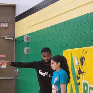 An adult coaching a student.