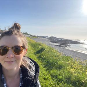 A person with a coast line behind them.