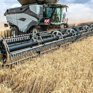 A large harvester collecting crops in a field.