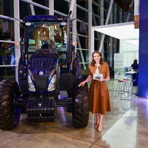 person standing with commemorative tractor