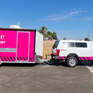 TMobile community support truck and pink trailer on the road