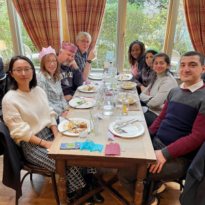 Kelly and others seated at a dining table