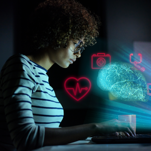 person working on laptop in the dark with artistic computer symbols shining from it