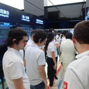 People in matching shirts walking through a display area