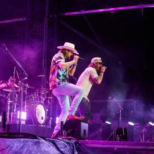 close up of lead singers of the band "Florida Georgia Line", lit up stage with fog effect