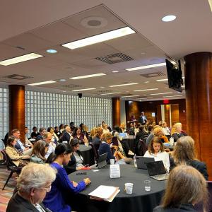 Tables of seated people in a conference room.