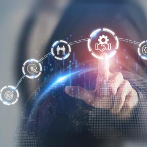 A person pointing to a digital rendering of symbols in an arch connected.