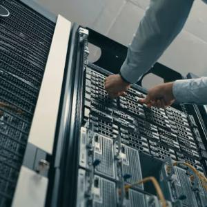 Technician installing server components inside a data center, supporting cloud computing and AI infrastructure.