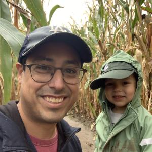 Matthew Sanchez and a child in a corn maze