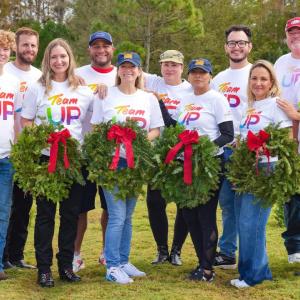 group posing with wreaths 