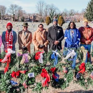 group posing with decorated wreaths 