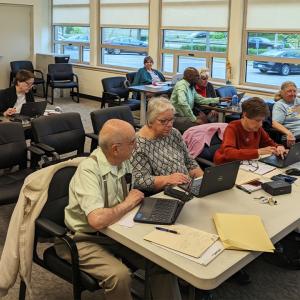 Group of people learning computer skills