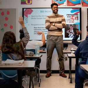 A teacher instructs his class of students 