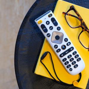new large button remote with glasses on a side table