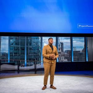 Man talking in front of screen