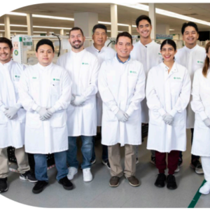 A group posed in protective lab gear.