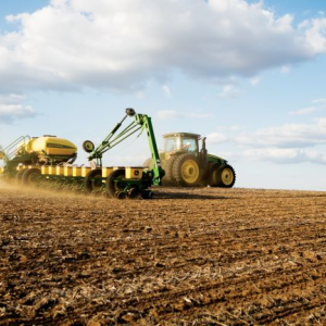 Tractor in field under blue sky