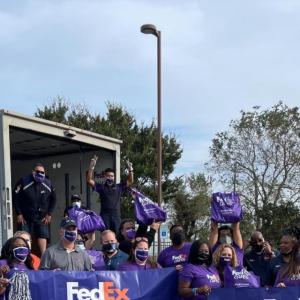 Crowd with purple tote bags