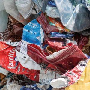 Plastic waste shown in the process of being sorted for recycling.