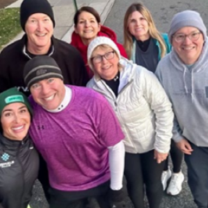 A group posed, taking a selfie outside.