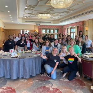 A team of people posed in a conference room.
