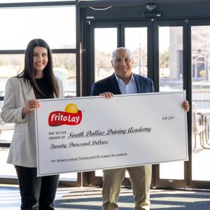 Two people holding a large check