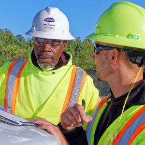 Lacardo Davis, left, and Joey Hunt start their day at a job site in Sumter, S.C., going over safety regulations. 