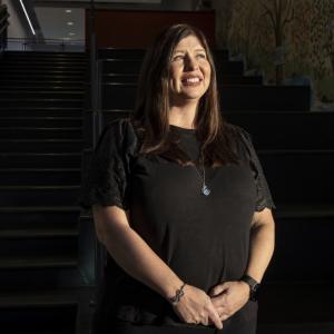 Dawn Martesi stood in front of a stair case