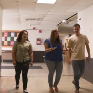 Martesi and two of her former Tiger Tech students walking through a corridor 