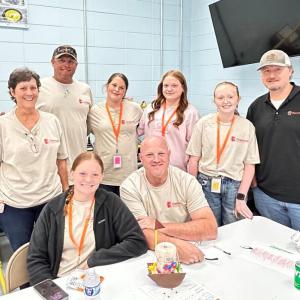 A group of 8 people posing in a cafeteria