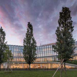 Exterior view of the Olympic House and trees in front.