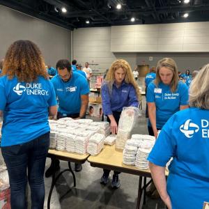 Volunteers stacking diapers at tables.